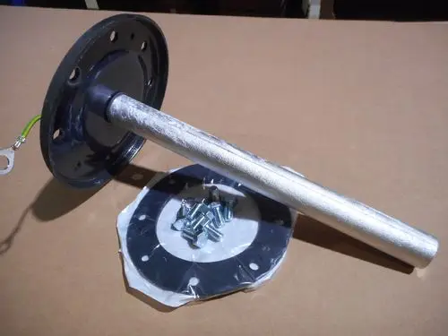 Seitenflansch mit Anode und Dichtung von Remeha, bestehend aus einem runden Flansch, einem metallischen Rohr und Schrauben, auf braunem Hintergrund.